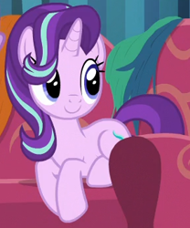 Size: 289x348 | Tagged: safe, screencap, starlight glimmer, pony, unicorn, it isn't the mane thing about you, behaving like a cat, cropped, cute, female, glimmerbetes, hair over one eye, mare, sitting, smiling, sofa, solo