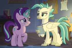 Size: 1145x766 | Tagged: safe, screencap, starlight glimmer, terramar, classical hippogriff, hippogriff, pony, unicorn, student counsel, book, cropped, duo, embarrassed, female, magic, magic aura, male, mare, raised eyebrow, raised hoof, raised leg, sheepish grin, silverstream's room, terramar is not amused, unamused