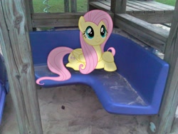 Size: 2048x1536 | Tagged: safe, artist:baumkuchenpony, artist:tokkazutara1164, fluttershy, bench, cute, irl, photo, plastic, playset, ponies in real life, prone, sand, sitting, smiling, solo, vector