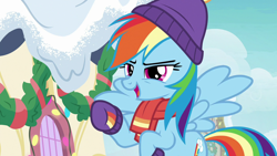 Size: 1280x720 | Tagged: safe, derpibooru import, screencap, rainbow dash, pegasus, pony, best gift ever, clothes, female, hat, mare, raised hoof, scarf, snow, solo