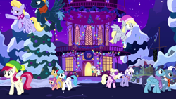 Size: 1280x720 | Tagged: safe, screencap, cherry cola, cherry fizzy, cloud kicker, derpy hooves, lightning bolt, mayor mare, roseluck, star hunter, white lightning, earth pony, pegasus, pony, best gift ever, background pony, earmuffs, female, filly, flying, hat, hearth's warming tree, holiday, male, mare, night, ponyville, ponyville town hall, snow, stallion, the true gift of gifting, town hall, tree, winter