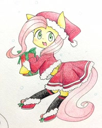 Size: 814x1024 | Tagged: safe, artist:yukimaki, fluttershy, pegasus, pony, clothes, hat, midriff, present, santa costume, santa hat, skirt, snow, socks, solo, traditional art