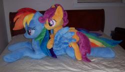 Size: 1379x800 | Tagged: safe, artist:agatrix, artist:penniesponyplushies, derpibooru import, photographer:vile-flesh, rainbow dash, scootaloo, bed, irl, photo, plushie, ponies in real life, ponies riding ponies