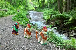 Size: 1953x1286 | Tagged: safe, artist:hihin1993, autumn blaze, cinder glow, summer flare, kirin, background kirin, female, follow the leader, forest, irl, japan, path, photo, plushie, river, stream