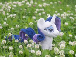 Size: 1000x750 | Tagged: safe, artist:valmiiki, rarity, bedroom eyes, clover, dat face, doll, flower, garden, irl, nature, outdoors, photo, plushie, solo, toy