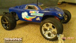 Size: 480x270 | Tagged: safe, artist:forzaveteranenigma, derpibooru import, rainbow dash, pegasus, pony, car, carpet, photo, radio control, rc car, solo, stadium truck, traxxas, traxxas rustler, truggy, watermark