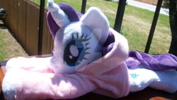 Size: 1024x576 | Tagged: safe, artist:siamchuchusplushies, rarity, beanie (plushie), clothes, hoodie, irl, photo, plushie, prone, solo, watermark