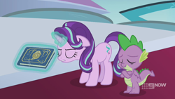 Size: 1280x720 | Tagged: safe, screencap, spike, starlight glimmer, dragon, pony, unicorn, memories and more, spoiler:memories and more, spoiler:mlp friendship is forever, 9now, book, crossed arms, duo, eyes closed, levitation, magic, magic aura, scrapbook, telekinesis, winged spike