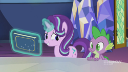 Size: 1280x720 | Tagged: safe, screencap, spike, starlight glimmer, dragon, pony, unicorn, memories and more, spoiler:memories and more, spoiler:mlp friendship is forever, 9now, book, duo, levitation, magic, magic aura, scrapbook, smiling, telekinesis, winged spike, worried, worried smile