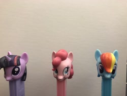 Size: 4032x3024 | Tagged: safe, derpibooru import, photographer:undeadponysoldier, pinkie pie, rainbow dash, twilight sparkle, pony, figure, funny, irl, pez dispenser, photo, simple background, totem, white background