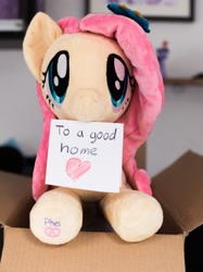Size: 1280x1707 | Tagged: safe, artist:pheiplushies, fluttershy, pony, adoption, box, cardboard box, cute, heart, irl, mouth hold, note, photo, plushie, pony in a box, shyabetes, solo