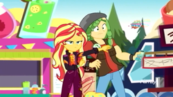 Size: 1280x720 | Tagged: safe, screencap, sandalwood, sunset shimmer, better together, equestria girls, sunset's backstage pass!, cellphone, clothes, discovery family logo, female, male, music festival outfit, pants, phone, smartphone