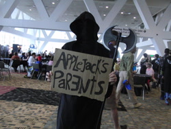 Size: 1024x768 | Tagged: safe, applejack, human, applejack's parents, bronycon, cardboard, clothes, cosplay, costume, crossing the line twice, dark comedy, grim reaper, implied death, irl, irl human, photo