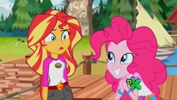 Size: 1280x720 | Tagged: safe, screencap, pinkie pie, sunset shimmer, equestria girls, legend of everfree, belt, boat, camp everfree outfits, confused, discovery kids, duo, duo female, female, grin, smiling