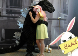 Size: 680x493 | Tagged: safe, angel bunny, fluttershy, kaiju, clothes, cosplay, costume, crossover, dress, glare, godzilla, godzilla (series), hug, looking at you