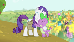 Size: 1280x720 | Tagged: safe, screencap, rarity, spike, dragon, pony, unicorn, inspiration manifestation, cute, eyes closed, female, hill, hub logo, hug, male, mare, outdoors, ponyville, saddle bag, smiling, standing