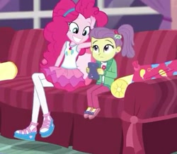 Size: 407x355 | Tagged: safe, derpibooru import, screencap, lily pad (equestria girls), pinkie pie, better together, equestria girls, pinkie sitting, clothes, cropped, female, hairband, jacket, magical geodes, out of context, pants, pantyhose, shoes, side ponytail, skirt, smiling, sofa, young