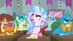 Size: 1600x900 | Tagged: safe, screencap, gallus, ocellus, sandbar, silverstream, smolder, yona, changedling, changeling, classical hippogriff, dragon, earth pony, griffon, hippogriff, pony, yak, school daze, bored, braid, classroom, claws, curved horn, desk, dragoness, eyeroll, eyes closed, female, folded wings, frown, hands on cheeks, head feathers, head on table, horn, horns, jewelry, looking up, male, narrowed eyes, necklace, open mouth, quill pen, student six, talons, teenaged dragon, teenager, wings, yawn