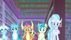 Size: 1280x720 | Tagged: safe, screencap, gallus, ocellus, sandbar, silverstream, smolder, yona, changedling, changeling, dragon, earth pony, griffon, hippogriff, pony, yak, what lies beneath, confused, dragoness, female, glow, jewelry, library, male, necklace, raised eyebrow, student six, teenager