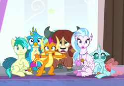 Size: 465x324 | Tagged: safe, screencap, gallus, ocellus, sandbar, silverstream, smolder, yona, changedling, changeling, classical hippogriff, dragon, earth pony, griffon, hippogriff, pony, yak, a matter of principals, bow, claws, cloven hooves, colored hooves, cutie mark, dragoness, female, hair bow, jewelry, male, monkey swings, necklace, shocked, student six, tail, teenager, wings