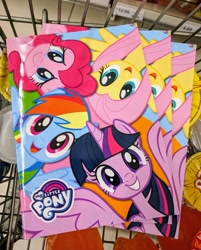 Size: 2189x2726 | Tagged: safe, derpibooru import, fluttershy, pinkie pie, rainbow dash, twilight sparkle, twilight sparkle (alicorn), alicorn, pony, book, cute, grin, irl, my little pony logo, official, photo, smiling, spread wings, wings