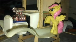 Size: 2560x1440 | Tagged: safe, fluttershy, pegasus, pony, everfree customs, garage, toy, trottingham milk float, truck