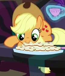 Size: 309x360 | Tagged: safe, screencap, applejack, earth pony, pony, made in manehattan, biscuits, cup, cute, eating, female, jackabetes, magic, mare, mouth hold, nom, prone, smiling, solo, teacup