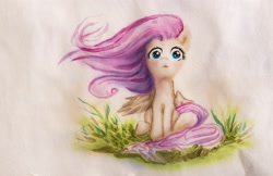 Size: 4588x2969 | Tagged: safe, artist:thevolshebniy, fluttershy, pegasus, pony, female, grass, looking at you, mare, one wing out, outdoors, sitting, solo, traditional art, watercolor painting, windswept mane