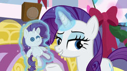 Size: 1280x720 | Tagged: safe, screencap, rarity, pony, unicorn, hearth's warming shorts, mystery voice, bedroom eyes, button eyes, female, hearth's warming doll, lidded eyes, magic, magic aura, mare, rarity plushie, self plushidox, solo, telekinesis