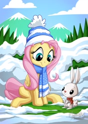 Size: 955x1351 | Tagged: safe, artist:mysticalpha, angel bunny, fluttershy, pegasus, pony, clothes, cloud, cute, female, looking down, mare, mountain, scarf, shyabetes, sitting, smiling, snow, tree, winter outfit