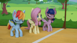 Size: 800x450 | Tagged: safe, derpibooru import, screencap, fluttershy, rainbow dash, twilight sparkle, twilight sparkle (alicorn), alicorn, pegasus, pony, my little pony: pony life, my little pony: stop motion short, the great race (short), animated, eyes closed, gif, grass, smiling, starting line, stop motion, tree, wings