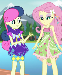 Size: 500x610 | Tagged: safe, screencap, bon bon, fluttershy, sweetie drops, equestria girls, legend of everfree, camp fashion show outfit, cropped, flower, lidded eyes, mountain, river, tree