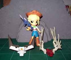 Size: 1121x950 | Tagged: safe, applejack, equestria girls, clothes, dead, deantler, decapitated, dispelow, doll, equestria girls minis, gat-22 30mm heavy machine gun, hunter, hunting, hunting trophy, implied murder, severed head, skirt, toy, zoids, zoids blox