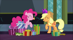 Size: 1361x762 | Tagged: safe, screencap, applejack, pinkie pie, earth pony, pony, a hearth's warming tail, bell, discovery family logo, present, scrunchy face