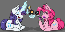 Size: 1662x818 | Tagged: safe, artist:emmsi-world, pinkie pie, rarity, earth pony, pony, unicorn, cupcake, curved horn, doll, eating, eyes closed, female, food, glowing horn, gray background, hairbrush, levitation, magic, mare, prehensile hair, prone, simple background, telekinesis, toy