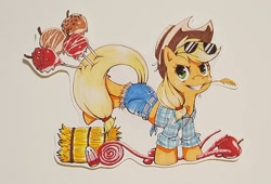 Size: 960x653 | Tagged: safe, artist:spirit-woods, applejack, earth pony, pony, apple, bucking, candy, candy apple (food), clothes, cowboy hat, daisy dukes, female, food, front knot midriff, grin, hat, hay bale, mare, marker drawing, midriff, shorts, smiling, solo, straw, sunglasses, traditional art