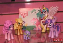 Size: 800x549 | Tagged: safe, applejack, pinkie pie, princess celestia, rarity, spike, twilight sparkle, alicorn, dragon, earth pony, pony, unicorn, 2010, 2010 asm toy fair, asm toy fair, female, hatless, irl, it begins, male, mare, missing accessory, my little pony logo, photo, pony history, prototype, start of ponies, toy, toy fair