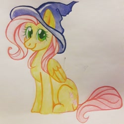 Size: 1210x1210 | Tagged: safe, artist:babuuroy, fluttershy, pegasus, pony, female, folded wings, hat, looking at you, mare, sitting, smiling, solo, traditional art, watercolor painting, wings, witch hat