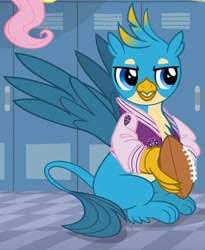 Size: 599x731 | Tagged: safe, screencap, fluttershy, gallus, griffon, pegasus, pony, season 8, american football, claws, clothes, cropped, jacket, letterman jacket, male, paws, solo focus, sports, varsity jacket, wings