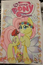 Size: 1024x1536 | Tagged: safe, artist:demise-the-art-demon, idw, fluttershy, pegasus, pony, bow, cover, female, floral head wreath, flower, mare, solo, tail bow, traditional art