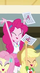 Size: 304x547 | Tagged: safe, screencap, applejack, fluttershy, pinkie pie, better together, equestria girls, the finals countdown, cropped, eyes closed, female, geode of sugar bombs, geode of super strength, grades, happy, magical geodes, smiling, success