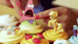 Size: 300x169 | Tagged: safe, applejack, human, cupcake, food, hand, irl, patrick star, photo, solo, spongebob squarepants, toy