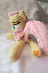 Size: 3648x5472 | Tagged: safe, artist:kazzysart, fluttershy, pegasus, pony, beanie (plushie), female, folded wings, irl, lidded eyes, mare, photo, plushie, prone, solo, underhoof, wings