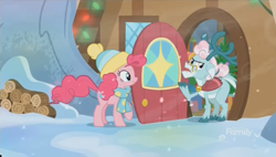 Size: 1348x768 | Tagged: safe, screencap, aurora the reindeer, pinkie pie, windy (g5), deer, earth pony, pony, reindeer, best gift ever, clothes, cloven hooves, doe, door, duo, female, hat, house, log, logs, mare, raised hoof, scarf, shawl, snow