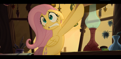 Size: 1920x937 | Tagged: safe, screencap, fluttershy, pegasus, pony, my little pony: the movie, bags under eyes, bipedal, female, floppy ears, lamp, lampshade, mare, scared, solo, teeth