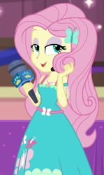 Size: 534x898 | Tagged: safe, screencap, fluttershy, best in show: the victory lap, better together, equestria girls, beautiful, best in show logo, clothes, cropped, cute, dress, eyeshadow, geode of fauna, lidded eyes, magical geodes, makeup, microphone, playing with hair, shyabetes, solo