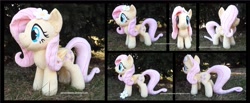 Size: 4275x1754 | Tagged: safe, artist:peruserofpieces, fluttershy, pegasus, pony, accessory, female, flower, flower in hair, folded wings, front view, happy, irl, long tail, mare, photo, plushie, profile, smiling, solo, toy, wings