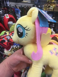 Size: 774x1032 | Tagged: safe, fluttershy, human, gamestop, hand, irl, irl human, luigi, megaman, photo, plushie, protoman, super mario bros.