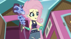 Size: 750x414 | Tagged: safe, screencap, fluttershy, better together, choose your own ending, equestria girls, the road less scheduled, the road less scheduled: fluttershy, alternate hairstyle, choker, clothes, eyeliner, eyeshadow, female, flutterpunk, lipstick, makeup, midriff, purple lipstick, skull, solo, spiked choker, staff, tanktop