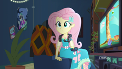 Size: 1600x900 | Tagged: safe, screencap, fluttershy, better together, choose your own ending, costume conundrum, equestria girls, controller, cute, headphones, poster, potted plant, shyabetes, sitting, sunset's apartment, television, video game